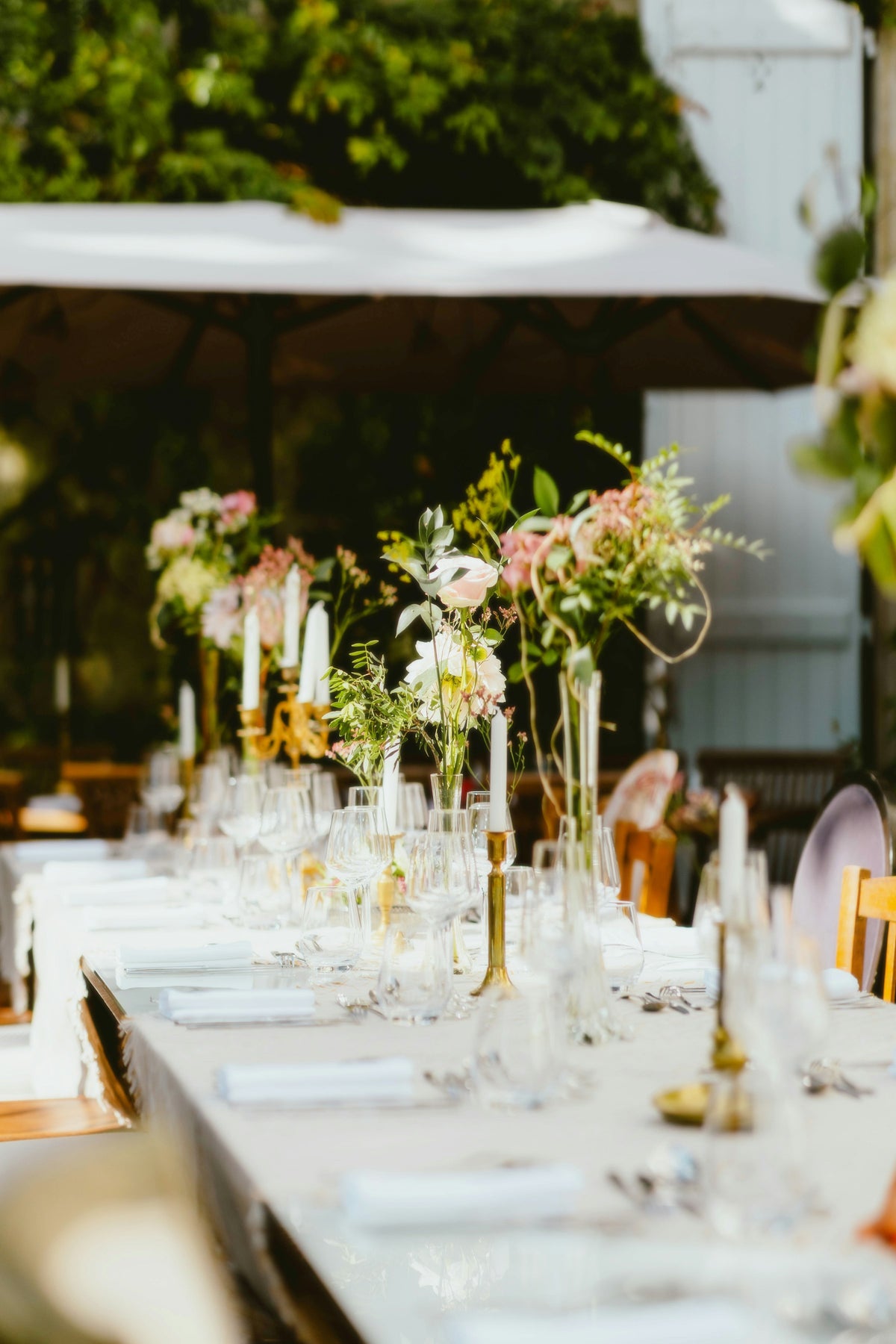 Heller Hochzeitstisch mit weißen Leinen und violetten Blumen